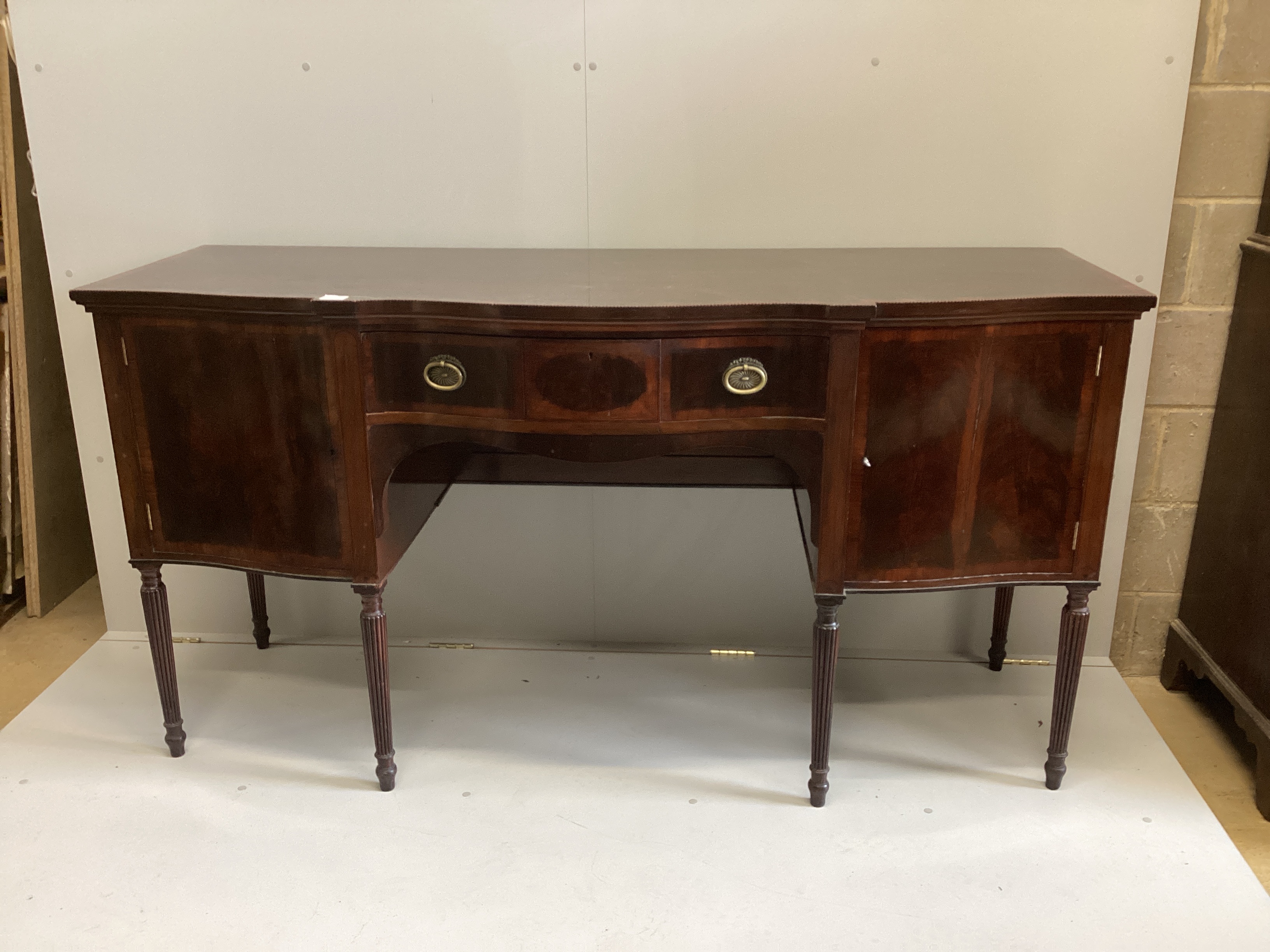 An Edwardian George III style Maple & Co banded mahogany serpentine sideboard, width 182cm, depth 69cm, height 97cm